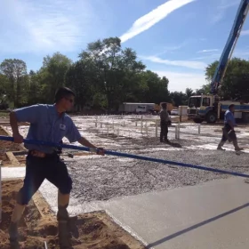 Concrete Workers Laying Concrete Foundation