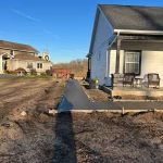 Fresh Poured and Paved Concrete Sidewalk and Excavated Property